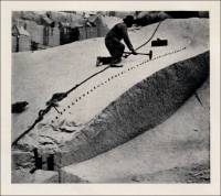 Plugs & feathers being used in a quarry in the Monument and Cemetery Review, 1923