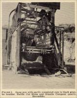 Gang saw with partly completed cuts in black granite boulder.