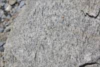 Closeup of piece of granite near entrance to Rosemary's Mountain Quarry, San Diego Co., CA