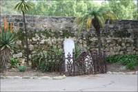 Marble cemetery stones in enclosed iron fence in the Santa Barbara Mission Cemetery, CA